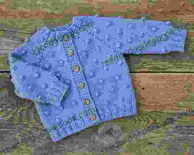 A Knitted Baby Sweater In A Light Blue Color With Buttons. Knit A Monster Nursery: Practical And Playful Knitted Baby Patterns