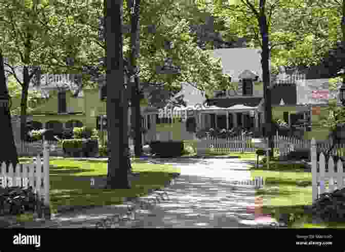 An Elegant Victorian Style Home With A Sprawling Lawn And Mature Trees, Bathed In The Warm Glow Of The Setting Sun. 4152 Witchwood Lane (Sisters Of Edgartown)